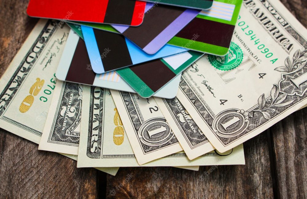 credit-card-and-dollars-on-wood_104376-207